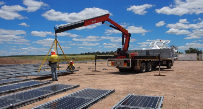 Contractors installing SunSHIFT's moveable solar farm at New Century Resource's Century Zinc Mine and processing plant.